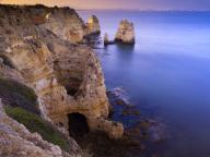 Portugal, Algarve, Scenic cliffs of Ponta da Piedade at dusk