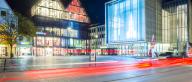 Germany, Ulm, Night shot of Kunsthalle Weishaupt atHans-und-Sophie-Scholl-Platz with light trails