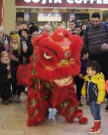(230129) -- SLIEMA, Jan. 29, 2023 (Xinhua) -- People watch lion dance in Sliema, Malta, Jan. 28, 2023. An event to celebrate the Chinese New Year or Spring Festival was held in a shopping mall in Sliema on Saturday. (Photo by Jonathan Borg\/Xinhua