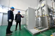 (240329) -- HARBIN, March 29, 2024 (Xinhua) -- Staff members check the devices at the fourth phrase of the Yilan Jiguan mountain windpower project in Yilan County, northeast China\'s Heilongjiang Province, March 28, 2024. The Yilan Jiguan mountain windpower project under the China Huadian Corporation (CHD) was put into full operation on Thursday. As the largest windpower project in northeast China\'s Heilongjiang Province, the four phrases of the project have a total installed capacity of 449 megawatts, and can generate an average of 1.24 billion kWh of power annually. (Xinhua\/Wang Jianwei
