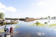 (240424) -- MANGOCHI, April 24, 2024 (Xinhua) -- A woman washes kitchen utensils at the lakeshore of Lake Malawi in Mangochi, Malawi, April 21, 2024. TO GO WITH "Feature: Rising waters of Lake Malawi displace hundreds, threatening livelihoods" (Photo by Joseph Mizere\/Xinhua