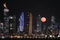 (240424) -- KUWAIT CITY, April 24, 2024 (Xinhua) -- The moon rises behind the skyline of Kuwait City, Kuwait, on April 24, 2024. (Photo by Asad\/Xinhua