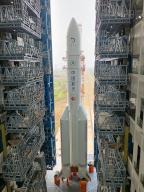 (240427) -- WENCHANG, April 27, 2024 (Xinhua) -- This photo taken on April 27, 2024 shows the combination of the Chang\'e-6 lunar probe and the Long March-5 Y8 carrier rocket being transferred vertically to the launching area at the Wenchang Space Launch Center in south China\'s Hainan Province. The Chang\'e-6 lunar probe is scheduled for launch at an appropriate time at the beginning of May, according to the China National Space Administration (CNSA). The combination of the Chang\'e-6 lunar probe and the Long March-5 Y8 carrier rocket was transferred vertically on Saturday to the launching area at the Wenchang Space Launch Center in south China\'s Hainan Province, the CNSA said. After Chang\'e 6 lunar probe and the Long March-5 Y8 carrier rocket arrived at the launch site in January and March, respectively, the assembly, testing and other preparations were successively completed. The probe is set to collect samples from the far side of the moon, marking a mission that will be the first of its kind in