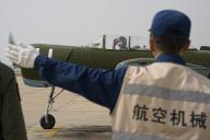 (240429) -- SHENYANG, April 29, 2024 (Xinhua) -- A member of the first group of female pilot trainees from the carrier-based aircraft of the Chinese People\'s Liberation Army Navy gives a sign to a staff member before taxiing in China, April 25, 2024. The first group of female pilot trainees from the carrier-based aircraft of the Chinese People\'s Liberation Army Navy has completed their inaugural solo flights, indicating that they are now capable of independently piloting an aircraft and conducting flights. TO GO WITH "Chinese female carrier aircraft pilot trainees complete solo flights" (Photo by Chen Chao\/Xinhua