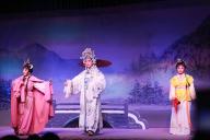 (240504) -- HAIKOU, May 4, 2024 (Xinhua) -- Lin Fang (R) and Chen Kehan (C) are pictured during a stage performance in Dingan County, south China\'s Hainan Province, April 23, 2024. Qiong Opera could be traced back to a century ago in Dingan County in this southern Chinese island, which is referred to as Qiong in abbreviation. The opera, now deemed a traditional heritage, had once lost its attraction to most youngsters due to the impacts of pop culture until recent years when the Dingan County Qiong Opera Troupe managed to reinvent it by drawing inspiration from other schools of traditional opera as well as folklore stories. Fresh bloods including Chen Kehan and Lin Fang are also being injected into the Troupe as Qiong Opera regains its popularity in the county. Chen\'s family has been working for the Troupe for three generations, while Lin started to learn the opera at age of six. Various kinds of activities are also being held at primary and secondary schools in the county so that the students