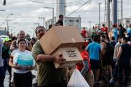 (240506) -- SCHARLAU, May 6, 2024 (Xinhua) -- Residents affected by flood receive supplies in Scharlau, Sao Leopoldo, in the state of Rio Grande do Sul, Brazil, May 5, 2024. At least 75 people have died from severe storms that inundated large swaths of south Brazil\'s Rio Grande do Sul state since April 29, the Civil Defense agency said in its latest report released Sunday. (Photo by Claudia Martini\/Xinhua