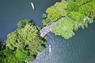 (240506) -- BEIJING, May 6, 2024 (Xinhua) -- An aerial drone photo taken on May 2, 2024 shows tourists visiting the West Lake in Hangzhou, east China\'s Zhejiang Province. China saw about 295 million domestic tourist trips during the five-day May Day holiday that ended Sunday, up 7.6 percent year on year and 28.2 percent from the same period in 2019, data from the Ministry of Culture and Tourism showed Monday. Domestic tourist expenditure during the period totaled 166.89 billion yuan (about 23.51 billion U.S. dollars), up 13.5 percent from the same period in 2019. (Photo by Long Wei\/Xinhua