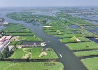 (240509) -- XIONG\'AN, May 9, 2024 (Xinhua) -- An aerial drone photo taken on May 8, 2024 shows boats cruising on Baiyangdian Lake in Xiong\'an New Area, north China\'s Hebei Province. Baiyangdian, the largest freshwater wetland in northern China, is located in the Xiong\'an New Area in Hebei. Since the Xiong\'an New Area was established in 2017, the lake\'s rehabilitation and protection activities have been bolstered. As of 2023, the water quality in Baiyangdian had maintained Grade III in the country\'s five-tier quality system for three consecutive years. (Xinhua\/Mu Yu