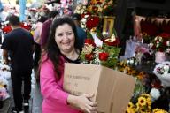 (240512) -- LOS ANGELES, May 12, 2024 (Xinhua) -- A shopper walks with bouquets at a flower market in downtown Los Angeles, California, the United States, May 11, 2024. The Mother