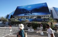 (240514) -- CANNES, May 14, 2024 (Xinhua) -- People walk past a huge poster of the 77th edition of the Cannes Film Festival outside the Palais du Festival in Cannes, southern France, May 13, 2024. This year