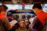(240514) -- HAIKOU, May 14, 2024 (Xinhua) -- Staff members of Grand China Aviation Maintenance Co., Ltd. (GCAM) operate inside the cockpit of an inbound airplane at a hangar of an aircraft maintenance base in Haikou, south China