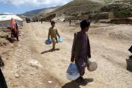 (240514) -- BAGHLAN, May 14, 2024 (Xinhua) -- Children carry flood-relief materials in Borka District, north Afghanistan