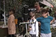 (240514) -- MARIBOR (SLOVENIA), May 14, 2024 (Xinhua) -- A boy looks through the scope of a mortar during the open day of the Slovenian Army in Maribor, Slovenia, on May 14, 2024. The Slovenian Army opened its doors to the public here on Tuesday to mark the Slovenian Army Day which falls on May 15. (Photo by Zeljko Stevanic/Xinhua