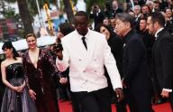 (240515) -- CANNES, May 15, 2024 (Xinhua) -- French actor Omar Sy (front), also a jury member of the 77th edition of the Cannes Film Festival, appears on the red carpet of the opening ceremony during the festival in Cannes, southern France, on May 14, 2024. The 77th edition of the Cannes Film Festival opened Tuesday on the French Riviera, with a selection of 22 films vying for the coveted Palme d