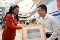 (240515) -- TIANJIN, May 15, 2024 (Xinhua) -- A staff member (R) of Tianjin International Cruise Home Port presents a souvenir to the home port