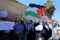 (240515) -- AMMAN, May 15, 2024 (Xinhua) -- People hold signs and Palestinian flags during a protest to mark the 76th anniversary of Nakba in Amman, Jordan, on May 15, 2024. (Photo by Mohammad Abu Ghosh/Xinhua