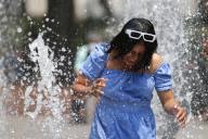(240516) -- MEXICO CITY, May 16, 2024 (Xinhua) -- A woman refreshes herself at a fountain in Mexico City, Mexico, on May 15, 2024. According to the National Meteorological Service of Mexico, the new round of heat wave ends this week but temperature will remain above 40 degree Celsius in many states. (Photo by Francisco Canedo/Xinhua