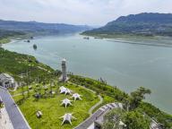 (240516) -- CHONGQING, May 16, 2024 (Xinhua) -- An aerial drone photo taken on May 15, 2024 shows a tourism area along the Yangtze River in Wanzhou District of Chongqing, southwest China. In recent years, Wanzhou District of Chongqing has actively carried out ecological protection and restoration of the Yangtze River. While strengthening the ecological barrier of the Three Gorges Reservoir region, the district also built waterfront leisure facilities, and achieved both ecological and social benefits. (Xinhua\/Wang Quanchao