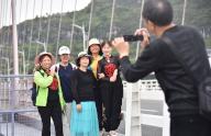 (240516) -- GUIYANG, May 16, 2024 (Xinhua) -- Tourists pose for photo on Longli River Bridge in Longli County, southwest China