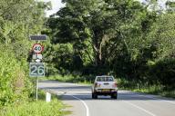 (240518) -- MASINDI, May 18, 2024 (Xinhua) -- A car passes by a speed sensor on a section of a Chinese-built road inside Murchison Falls National Park in northwest Uganda, on May 11, 2024. TO GO WITH "Feature: Chinese-built Uganda road transforms lives, boosts economy" (Photo by Hajarah Nalwadda/Xinhua