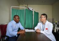 (240518) -- MALABO, May 18, 2024 (Xinhua) -- Tian Huaigu (R), head of the Chinese medical team, talks with Reynolds Ondoua Trillo, technical director of Malabo Regional Hospital, at the hospital in Malabo, Equatorial Guinea, on May 16, 2024. The 33rd batch of Chinese medical team to Equatorial Guinea has been providing medical services for people of Equatorial Guinea since December 2023. (Xinhua/Han Xu
