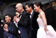 (240518) -- CANNES, May 18, 2024 (Xinhua) -- Chinese director Guan Hu (3rd R) and cast members Zhou You (1st L), Liang Jing (2nd L), Eddie Peng (2nd R) and Tong Liya arrive at the red carpet for the film "Gou Zhen" (Black Dog) during the 77th edition of the Cannes Film Festival in Cannes, southern France, on May 17, 2024. The film "Gou Zhen" (Black Dog) is in competition for the category Un Certain Regard of the festival. (Xinhua\/Gao Jing
