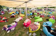 (240518) -- SEOUL, May 18, 2024 (Xinhua) -- Competitors take part in a sleep competition in Seoul, South Korea, May 18, 2024. A sleep competition was held at Yeouido Han River Park in Seoul Saturday to help citizens relax and experience the fun of taking nap outdoors. (Xinhua/Yao Qilin
