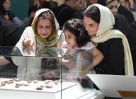 (240519) -- TEHRAN, May 19, 2024 (Xinhua) -- People watch ancient clay tablets at National Museum of Iran in Tehran, Iran, May 18, 2024. Iran on Saturday unveiled a selection of ancient clay tablets brought back to the country last year from the United States. TO GO WITH "Iran unveils selection of ancient clay tablets returned from U.S." (Xinhua\/Shadati