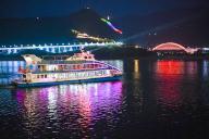 (240519) -- CHONGQING, May 19, 2024 (Xinhua) -- Tourists take a sightseeing boat to enjoy night scenery in Wushan County, southwest China