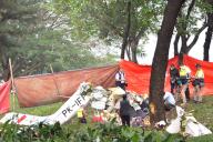 (240519) -- TANGGERANG, May 19, 2024 (Xinhua) -- Rescuers investigate near debris of a small plane after crash in Tanggerang city bordering Jakarta, Indonesia, on May 19, 2024. A small plane carrying three people went down in Tanggerang city bordering Indonesia
