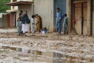 (240519) -- FARYAB, May 19, 2024 (Xinhua) -- People stand by a muddy road following flash flooding in Maimana, the capital of north Afghanistan