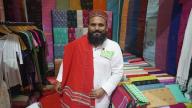 (240520) -- DHAKA, May 20, 2024 (Xinhua) -- A man shows products at a stall during Bangladesh