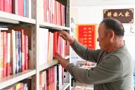 (240520) -- LANZHOU, May 20, 2024 (Xinhua) -- An Weizhi arranges books at his library in Sunan Yugur Autonomous County of Zhangye City, northwest China