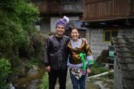 (240520) -- NANNING, May 20, 2024 (Xinhua) -- Wu Xinren (L) and his wife He Yuqing pose for a photo in Wuying Village on the border between south China
