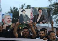 (240520) -- BAGHDAD, May 20, 2024 (Xinhua) -- People gather in front of the Iranian embassy in Iraq in Baghdad, Iraq, to offer condolences for the victims of the helicopter crash near Varzaqan County, Iran, on May 20, 2024. Iranian President Ebrahim Raisi and some members of his accompanying team, including Foreign Minister Hossein Amir-Abdollahian, were confirmed dead Monday morning as the wreckage of the helicopter carrying them was found following its crash in bad weather on Sunday near Varzaqan County, some 670 km away from Tehran. (Xinhua/Khalil Dawood
