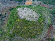 (240521) -- GUIYANG, May 21, 2024 (Xinhua) -- An aerial drone photo taken on May 16, 2024 shows ancient fortifications dating back the Qing Dynasty (1644-1911) on the hilltop in Longan Village of Xingyi City, southwest China