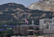 (240521) -- DAMASCUS, May 21, 2024 (Xinhua) -- A Syrian national flag flies at half-mast to mourn for the deaths of Iranian President Ebrahim Raisi, Foreign Minister Hossein Amir-Abdollahian and other people killed in a helicopter crash, in Damascus, Syria, May 20, 2024. (Photo by Ammar Safarjalani/Xinhua