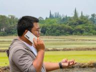 (240521) -- CHENGDU, May 21, 2024 (Xinhua) -- Shu Xingyu talks on the phone with a local farmer about the service terms for agricultural machines in Shiqiao Village of Chongzhou City, southwest China