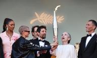 (240522) -- CANNES, May 22, 2024 (Xinhua) -- Delphine Ernotte (2nd R), head of France Televisions, holds the Paris 2024 Olympic torch at the 77th edition of the Cannes Film Festival in Cannes, southern France, on May 21, 2024, as part of the Olympics torch relay. (Xinhua/Gao Jing