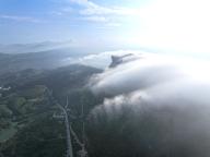 (240523) -- CHONGQING, May 23, 2024 (Xinhua) -- An aerial drone photo taken on May 23, 2024 shows clouds streaming down the Jinfo Mountain in Nanchuan District, southwest China