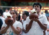 (240523) -- COLOMBO, May 23, 2024 (Xinhua) -- People take part in a religious observance of the Vesak Festival at a temple in Colombo, Sri Lanka, May 23, 2024. The Vesak Festival is one of the holiest festivals celebrated in Sri Lanka as it marks the birth, enlightenment and demise of Lord Buddha. (Photo by Ajith Perera/Xinhua