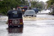 (240524) -- WATTHALA, May 24, 2024 (Xinhua) -- Vehicles run on a flooded road in Watthala, Sri Lanka, on May 24, 2024. (Photo by Gayan Sameera/Xinhua