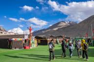 (240525) -- LHASA, May 25, 2024 (Xinhua) -- Tourists walk in a base camp of Mount Qomolangma in southwest China