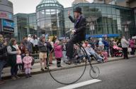 (240526) -- NEW WESTMINSTER, May 26, 2024 (Xinhua) -- A performer rides a vintage bicycle during the annual Hyack International Parade in New Westminster, British Columbia, Canada, on May 25, 2024. (Photo by Liang Sen/Xinhua