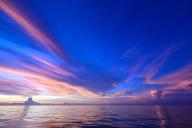 (240527) -- HAIKOU, May 27, 2024 (Xinhua) -- This photo taken on May 1, 2024 shows a view at dusk in the South China Sea. The calm sea, colorful clouds, starry night sky, magnificent sunrise and sunset unfold slowly like a picture scroll in the South China Sea. (Xinhua/Pu Xiaoxu