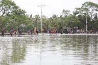 (240529) -- KHULNA, May 29, 2024 (Xinhua) -- People fish in a flooding river in Khulna, Bangladesh, May 28, 2024. At least 10 people were killed as Cyclone Remal slammed Bangladesh