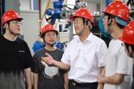 (240530) -- CHENGDU, May 30, 2024 (Xinhua) -- Zhong Yuanzhang (3th L) communicates with colleagues on an experimental platform in Nuclear Power Institute of China in Chengdu, southwest China