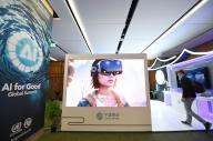 (240531) -- GENEVA, May 31, 2024 (Xinhua) -- A participant visits the exhibition booth of China Mobile at the 2024 Artificial Intelligence (AI) for Good Global Summit in Geneva, Switzerland, May 30, 2024. The 2024 Artificial Intelligence (AI) for Good Global Summit began on Thursday in the Swiss capital of Geneva. (Xinhua/Lian Yi
