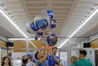 (240601) -- BUCHAREST, June 1, 2024 (Xinhua) -- Organizers carry balloons during the opening day of SpaceFEST 2024 at Politehnica University of Bucharest in Bucharest, Romania, May 31, 2024. The SpaceFEST is an event dedicated to science, innovation and space exploration, with discussions and presentations about the future of space flight, emerging technologies and collaboration opportunities in the aerospace industry. (Photo by Cristian Cristel/Xinhua