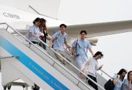 (240601) -- SHANGHAI, June 1, 2024 (Xinhua) -- Hong Kong students get off the C919 jetliner at the Shanghai Hongqiao International Airport in Shanghai, east China, June 1, 2024. A C919 jetliner of the China Eastern Airlines fleet on Saturday kicked off its first overseas commercial chartered flight, providing a round-trip service between Shanghai and Hong Kong. Flying from the Shanghai Hongqiao International Airport to the Hong Kong International Airport Saturday morning, it carried more than 100 Hong Kong young talents on its return trip on the same day. The Hong Kong young talents are reported to be in Shanghai for internship, visits and exchange activities. (Xinhua/Liu Ying